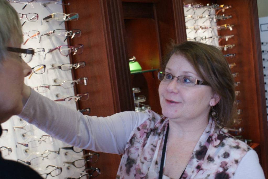 Adjusting eye glasses on woman's face