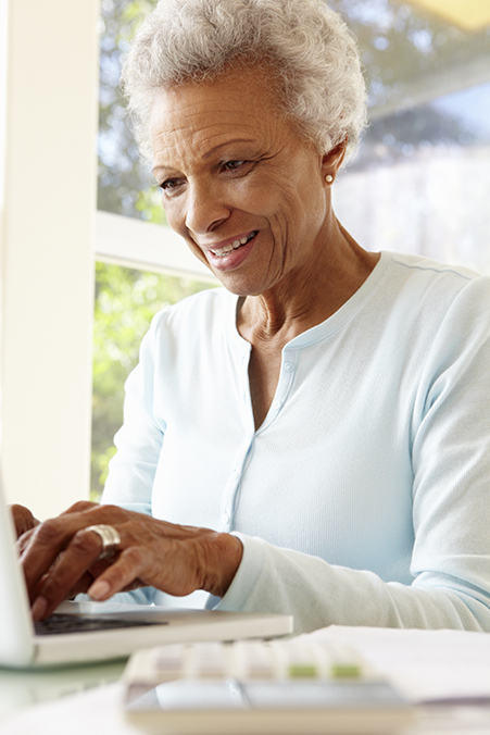 Senior Woman Using Laptop At Home