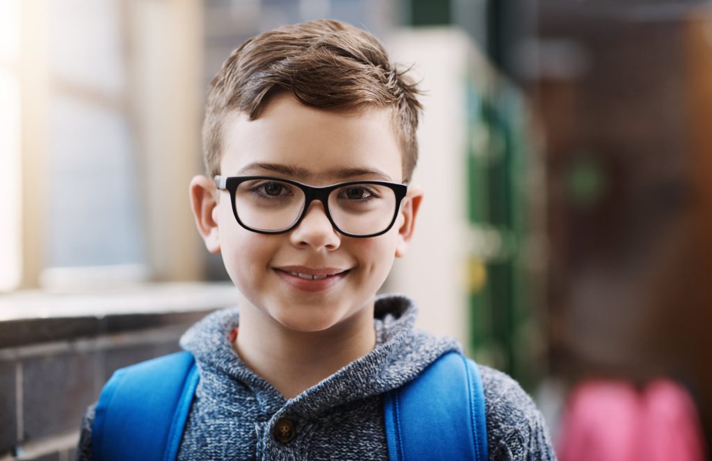 Boy smiling with glasses